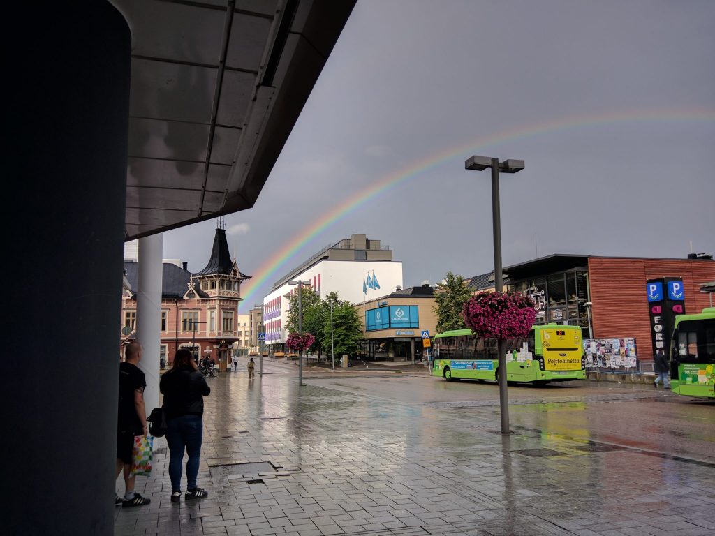 People taking photos of a rainbow at the bus terminal in the center of Jyväskylä, Finland.
